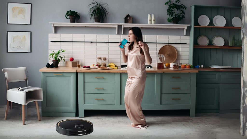 Mother in kitchen and Robot Vacuum Cleaner