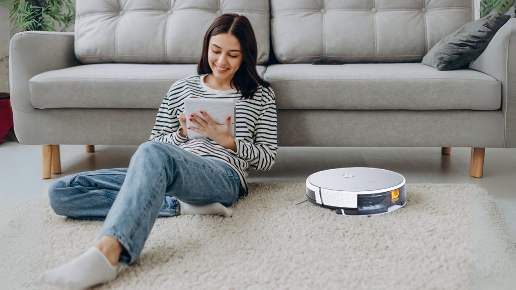 Mother working and robot vacuum cleaner