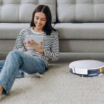 Mother working and robot vacuum cleaner