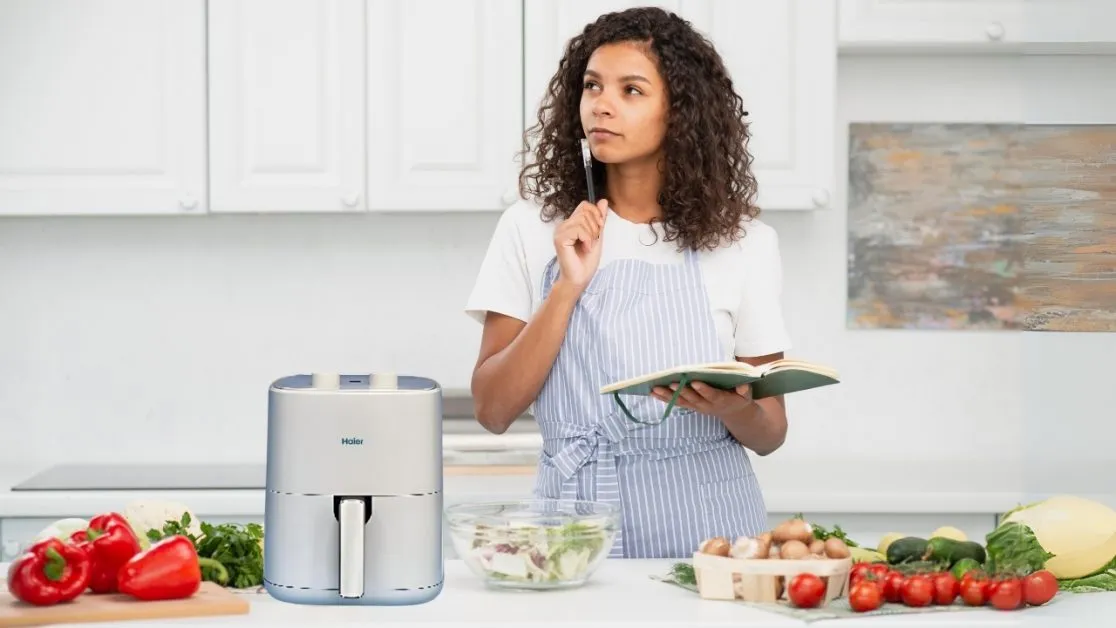 Woman making vegetable fried food in air fryer (2)